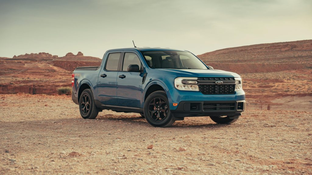 A blue Ford Maverick pickup truck in a serene desert landscape near Page, Arizona.